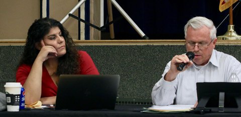 Councilmember Dave Brown speaks as Councilmember Holly Brown looks on.